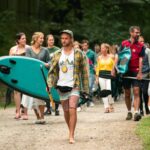 Teilnehmer laufen mit Kursleiter zum Kanusee bei SOMMERJUNG, dem Ferienlager für Erwachsene